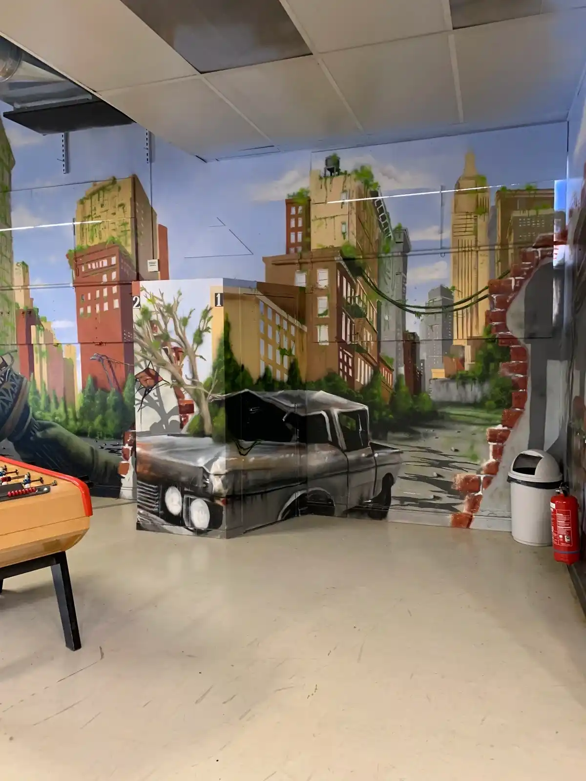 Espace d'accueil de l'ancien Laser Game Bourgoin avec décor urbain